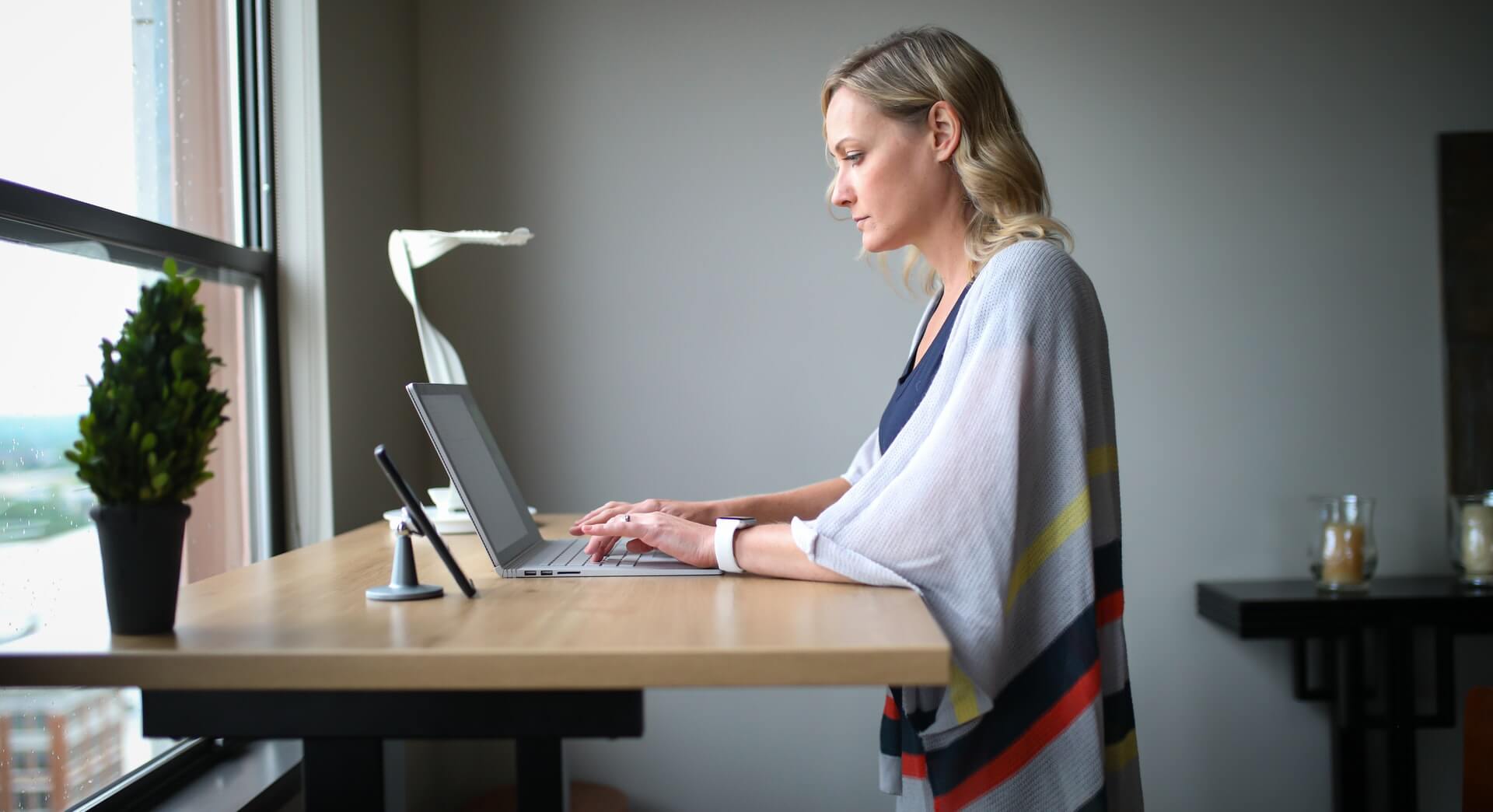 a girl working using sit stand desk