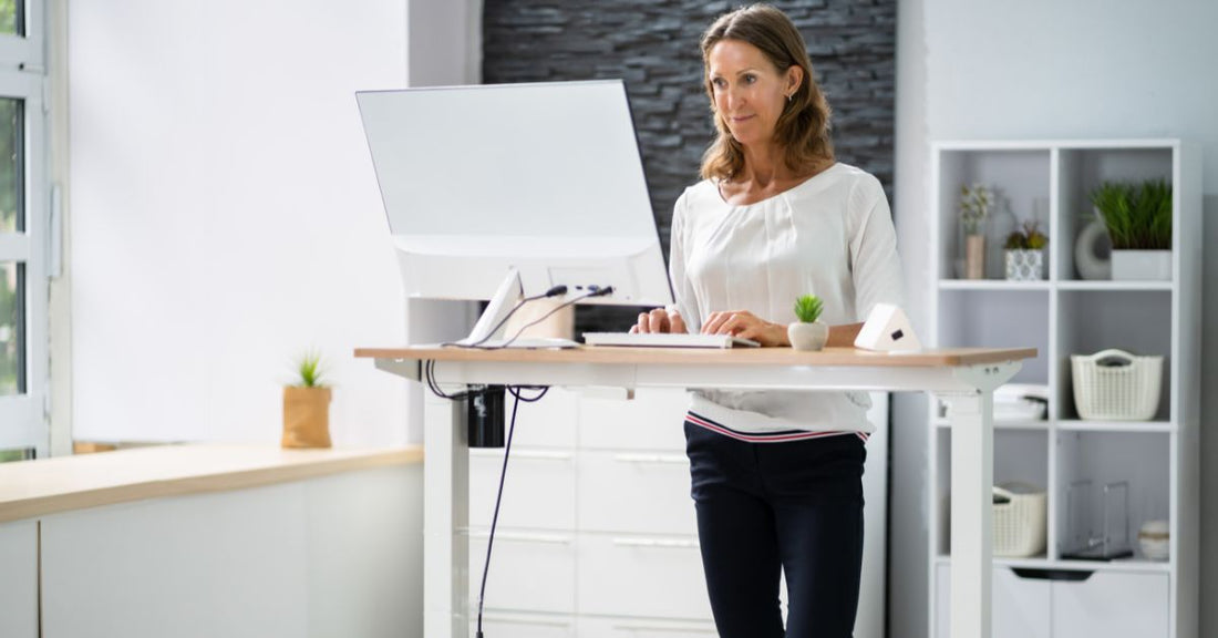 women working on a standing desk in office